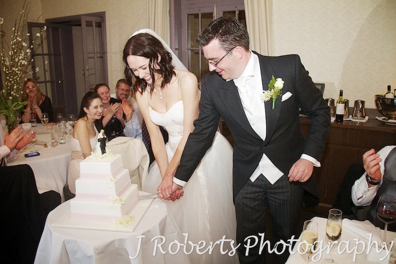Bride and groom cutting the cake - wedding photography sydney